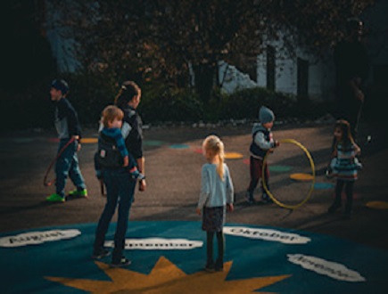 spielende Eltern und Kinder auf dem Schulhof